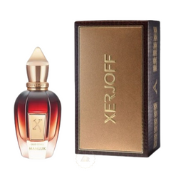 Product photography of a Xerjoff Oud Stars Mamluk perfume bottle and its accompanying box the elegant bottle features a red-to-clear gradient glass body with a gold 'X' emblem and a golden spired cap positioned next to a rectangular dark brown and gold box displaying the 'XERJOFF' logo