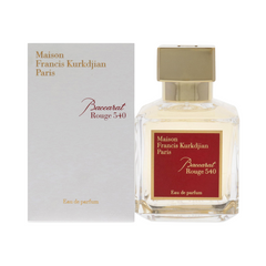 Product photo by Maison Francis Kurkdjian Paris showing a Baccarat Rouge 540 Eau de Parfum clear glass bottle with a gold cap and a distinct red label, presented next to its white box featuring matching gold and red lettering