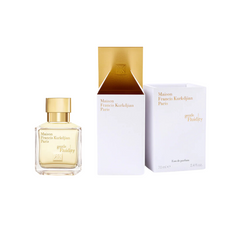 Maison Francis Kurkdjian Paris Gentle Fluidity fragrance in a clear rectangular glass bottle with a radiant gold cap alongside its elegant white packaging box featuring a shimmering gold interior and delicate gold text displaying 70ml Eau de parfum