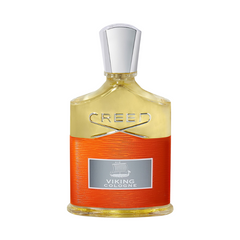 Creed Viking Cologne perfume bottle featuring a gold upper section with silver CREED lettering, a textured vibrant orange lower half, and a grey label with a Viking longboat graphic