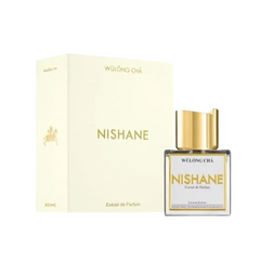 Product photography featuring a Nishane Wulong Cha Extrait de Parfum clear glass bottle with a shiny gold cap and Shanghai label positioned next to its creamy white box adorned with gold Nishane lettering and a distinctive gold horse emblem