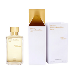 Maison Francis Kurkdjian Paris "Gentle Fluidity" eau de parfum bottle a clear rectangular glass with gold cap and MFK monogram displayed alongside its elegant white luxury packaging revealing a golden interior and 200 ml volume