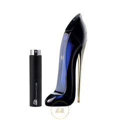 Product photograph of a dark blue glass Carolina Herrera Good Girl perfume bottle shaped like a high heel shoe with a gold stiletto heel beside a black cylindrical Fragrance Lord travel atomizer