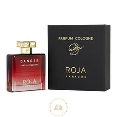 Product photograph of Roja Parfums Danger Parfum Cologne, showcasing a rectangular red gradient glass bottle with a gold faceted cap and 'DANGER' label next to a matte black box with gold 'ROJA PARFUMS' text on a white background