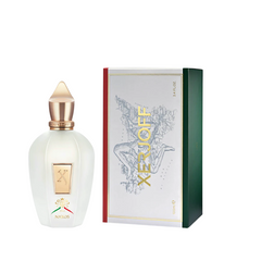 Photograph of a Xerjoff Naxos perfume bottle and box showcasing Sicilian iconography with the Trinacria symbol and a map of Sicily on the white box front, featuring a frosted white bottle with a prominent gold X emblem, a gold cap, and "NAXOS" text, complemented by the box's distinctive red and green Italian flag-colored sides