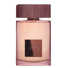 Product photography by Tom Ford of the Cafe Rose perfume bottle, featuring a ribbed pinkish-rose tinted glass design, a matching cap, and a prominent dark brown label with the fragrance name
