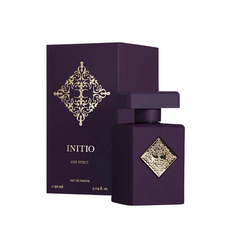 Initio Side Effect Eau de Parfum bottle and its matching rectangular box, both in matte dark purple, showcasing an ornate gold emblem and the product name 'Initio Side Effect' on a white background