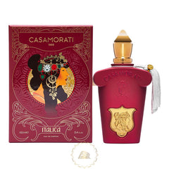 Casamorati Italica perfume box and bottle showcasing rich red and gold packaging with an ornate woman's profile in an elaborate jeweled headdress and a matching deep red bottle featuring a gold crest and white tassel