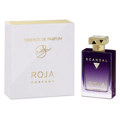 Roja Parfums Scandal Essence de Parfum displayed with its white and gold box and a deep purple gradient bottle featuring gold lettering, an intricate geometric gold cap, and a silver triangular emblem