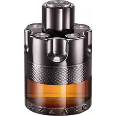 Product photo of Azzaro Wanted perfume bottle on a white background featuring a distinctive gunmetal grey revolver cylinder design a textured diamond patterned band and amber-colored liquid