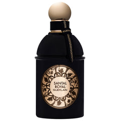 Product photography Guerlain Santal Royal perfume bottle, a black flacon with a round gold cap, a decorative gold label featuring ornate floral patterns and text, and a black and gold braided ribbon tied around its neck