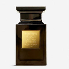 A product photograph showcasing the Tom Ford Tuscan Leather Intense Eau de Parfum 100ml bottle, identifiable by its dark brown rectangular glass, sleek black cap, and prominent gold label with black lettering