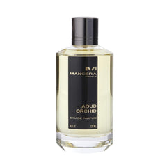 Product photography of a Mancera Paris Aoud Orchid Eau de Parfum bottle, a clear rectangular glass container with a black vertical label displaying gold Aoud Orchid text, and a dark metallic cap revealing light amber liquid inside