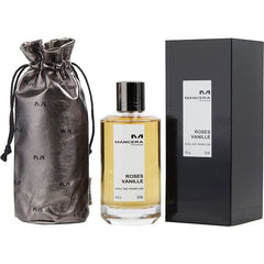 Product photography of Mancera Paris Roses Vanille Eau de Parfum in a clear glass bottle with amber liquid, a black box, and a metallic gray drawstring pouch patterned with the M logo
