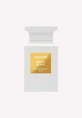 Product photograph by Tom Ford of a white Soleil Blanc Eau de Parfum 100ml bottle with an elegant architectural cap and a prominent golden label on a clean white background