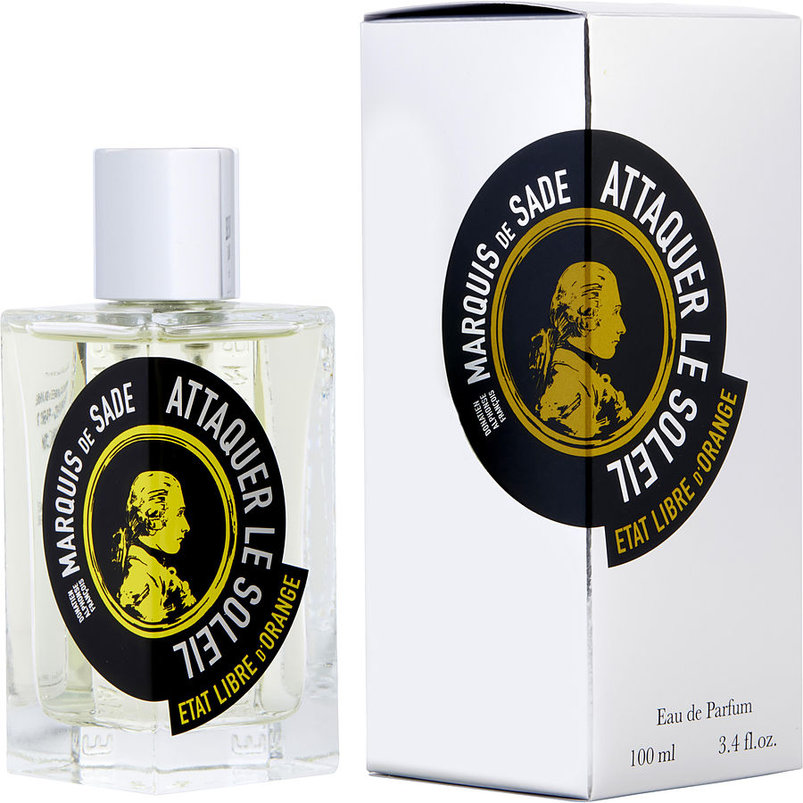 Etat Libre d'Orange Attaquer le Soleil Marquis de Sade Eau de Parfum in a clear glass bottle with a silver cap and its white and silver box, both featuring a striking circular black and gold label with a profile portrait of the Marquis de Sade