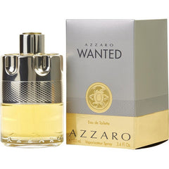 Azzaro Wanted Eau de Toilette fragrance bottle with a unique chrome bullet-cylinder design holding golden yellow liquid displayed next to its silver-grey and gold box featuring the bold WANTED title and a distinctive gold circular emblem on a white background