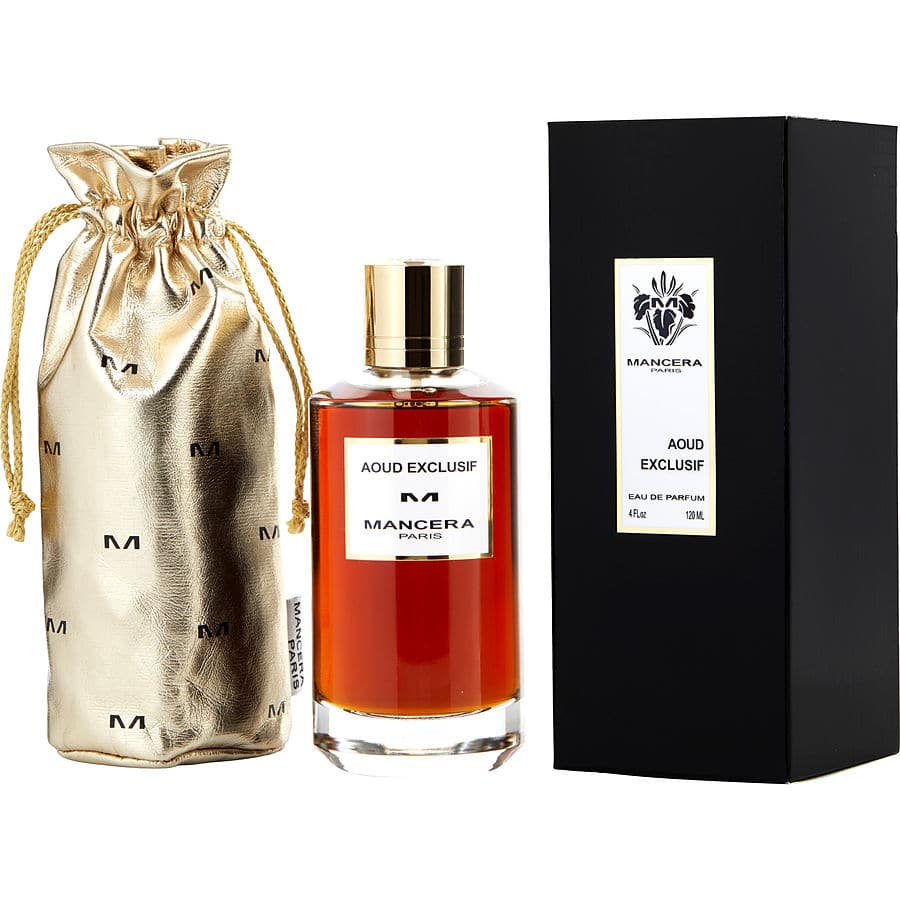 Product photograph of Mancera Paris Aoud Exclusif Eau de Parfum featuring an amber-colored liquid in a clear bottle with a gold cap, alongside a black box with a white label and a gold metallic drawstring pouch emblazoned with repeating M logos