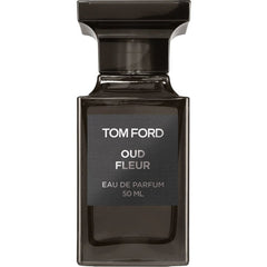 Product photography of Tom Ford Oud Fleur Eau de Parfum in a sleek dark rectangular glass bottle with a prominent black cap and a matte black label displaying white text including the brand name and 50 ML volume