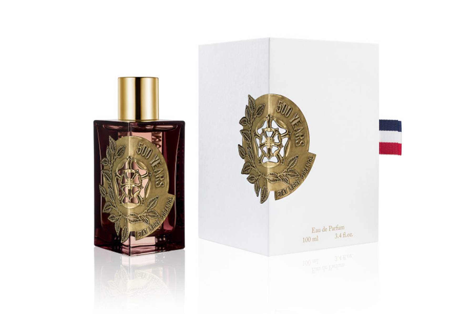 Etat Libre d'Orange 500 Years luxury perfume bottle and white box displaying a dark amber glass bottle with a gold cap and intricate gold medallion featuring a stylized rose, '500 YEARS' text, and a French tricolor ribbon detail