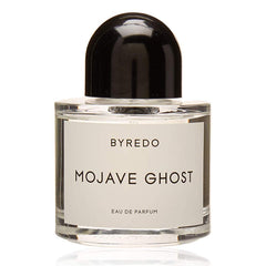 Product photography of a Byredo Mojave Ghost Eau de Parfum in a clear glass bottle with a prominent black domed cap and a white label displaying the fragrance name on a minimalist white background