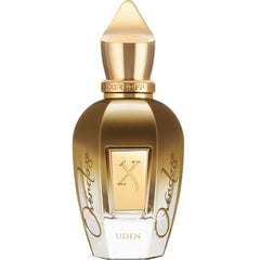 Product photograph of the Xerjoff Uden Overdose perfume bottle, a striking gold and clear glass design featuring a pointed gold cap, prominent XERJOFF branding on the neck, and an embossed X logo on the front