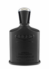 Product photograph of a Creed Green Irish Tweed fragrance bottle, featuring a matte black finish, an elegant polished black cap with a prominent gold crest, and embossed CREED branding with Green Irish Tweed text