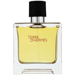 Photograph of a Terre D'Hermès fragrance bottle featuring clear rectangular glass a yellowish amber liquid a contrasting black and silver cap and distinct red lettering