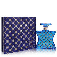 Photograph of Bond No. 9 NoMad NYC fragrance featuring a deep blue hourglass-shaped bottle and its matching box, both adorned with an intricate gold lattice pattern and sparkling crystal-like embellishments