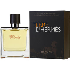 Hermès Terre d'Hermès perfume bottle with amber liquid and a black cap alongside its matte black box displaying orange and white text with the subtle brown Hermès horse and carriage logo and 75ml volume