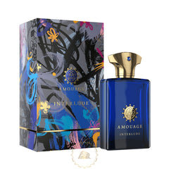 Amouage Interlude Man perfume featuring a deep blue rectangular bottle with a gold crown cap and blue gem, accompanied by its abstract art box adorned with vibrant blue, yellow, and black brushstrokes on a grey background