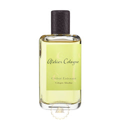Atelier Cologne Cédrat Enivrant Cologne Absolue in a clear rectangular glass bottle with a dark textured cap and a light green swirl-patterned label holding pale yellow liquid on a white background