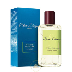 Product photo of Atelier Cologne Cédrat Enivrant Cologne Absolue perfume bottle with a dark red cap and light green label featuring a subtle swirling design, next to its vibrant blue box from Paris