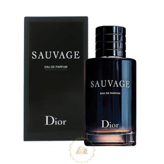 Product photography of a Dior Sauvage Eau de Parfum fragrance featuring a dark blue to black gradient glass bottle with a ribbed black magnetic cap standing next to its matching matte black box against a white background