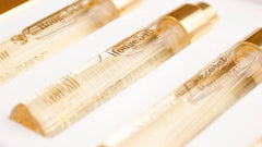 Three golden-capped Baccarat Rouge 540 Eau de Parfum sample vials with amber liquid clearly visible on a white background