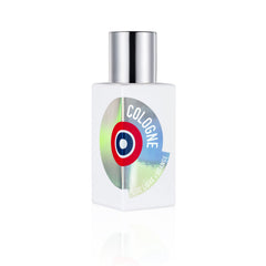 Product photography of Etat Libre d'Orange's square white cologne bottle with a silver cap and a shimmering holographic label displaying a red and blue target logo and the word COLOGNE