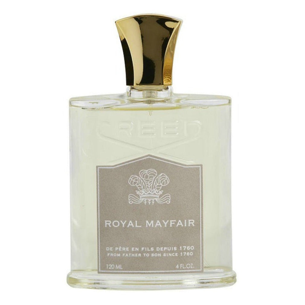 Product photograph of Creed Royal Mayfair fragrance bottle, a clear glass vessel with a golden cap and a beige label featuring the brand's crest and historical text "From father to son since 1760" evoking its London Mayfair origins