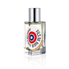 Digital photograph of Etat Libre d'Orange Fils de Dieu Du Riz et des Agrumes perfume bottle, a clear rectangular glass bottle with a shiny silver cap and a bold circular red white and blue target logo label
