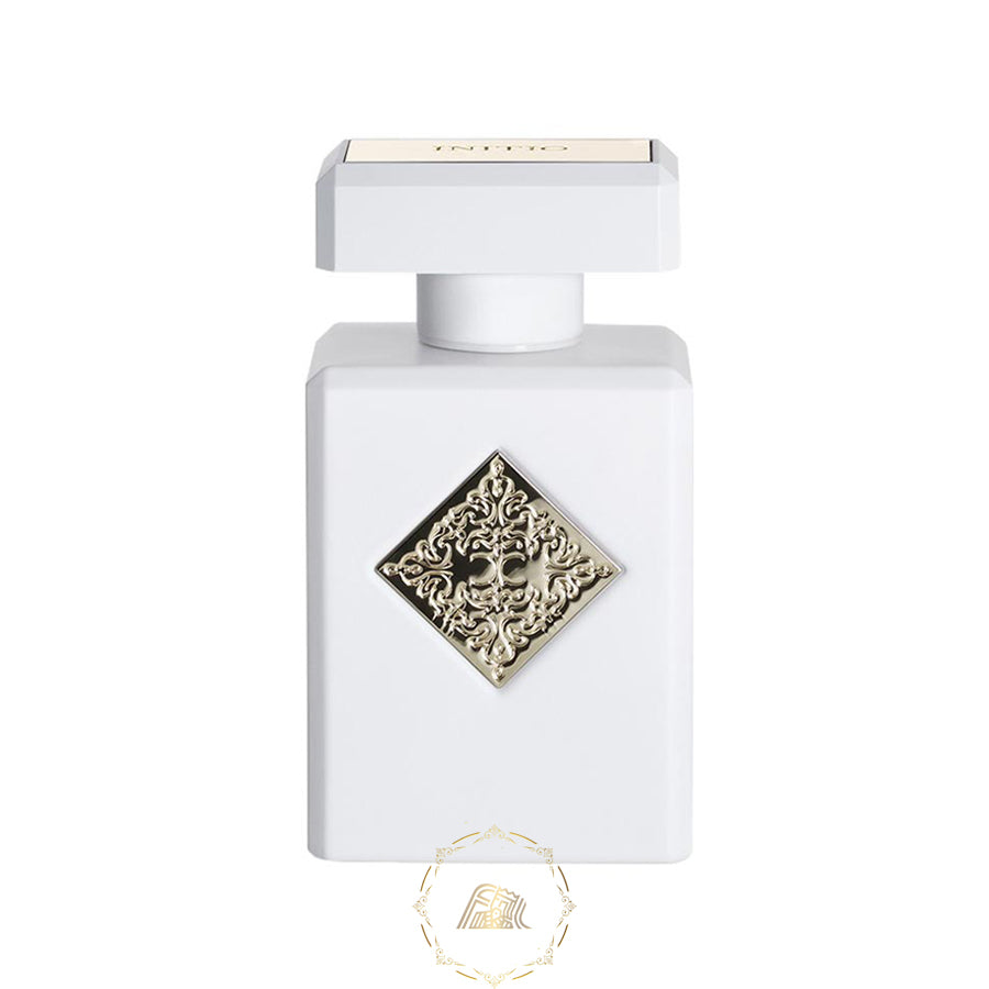 Product photography of a white rectangular Initio Parfums Prives fragrance bottle featuring a prominent gold ornate diamond emblem with CC initials and INITIO text on the cap