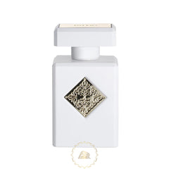 Product photography of a white rectangular Initio Parfums Prives fragrance bottle featuring a prominent gold ornate diamond emblem with CC initials and INITIO text on the cap