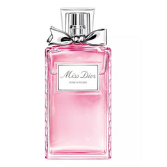 Product Photography by Dior a Miss Dior Rose N'Roses perfume bottle with a clear rectangular glass design, bright pink liquid, embossed sides, and a shimmering silver bow