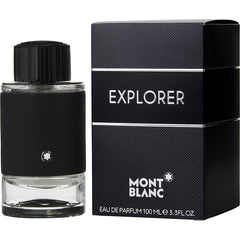 Product photography by Montblanc of the Explorer Eau de Parfum bottle and its textured black box featuring the iconic Montblanc star logo on the matte black bottle sleeve with a clear glass base and silver "EXPLORER" and "MONT BLANC" text on the box