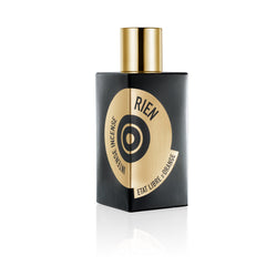 Product photo of Etat Libre d'Orange Rien Intense Incense perfume bottle on a white background, featuring a matte black rectangular bottle with a shiny gold cylindrical cap and a striking gold circular label displaying black concentric rings and brand typography