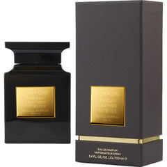 Tom Ford product photography of a sleek black square bottle of Tuscan Leather Intense Eau de Parfum with a prominent gold label next to its dark grey textured box showcasing gold accents and 100 ml volume