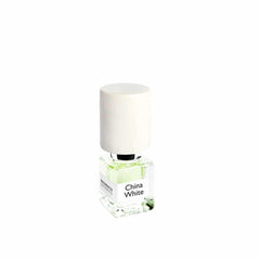 Nasomatto China White perfume bottle featuring a clear square glass, pale green liquid, and a tall textured white cylindrical cap with the brand name visible