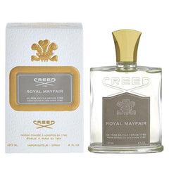 Creed Royal Mayfair fragrance in its elegant white and gold box and clear rectangular glass bottle with a prominent gold cap and embossed crest, reflecting its London and Paris origins