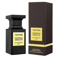 Photo of Tom Ford Champaca Absolute Eau de Parfum 50ml, featuring an elegant black glass bottle and a textured black rectangular box on a white background, both adorned with prominent gold labels detailing the scent and volume