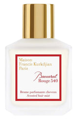 Product photo by Maison Francis Kurkdjian Paris of a Baccarat Rouge 540 Scented hair mist bottle with a frosted white glass body, shiny gold cap, and a prominent red label displaying brand and product name in gold and red script