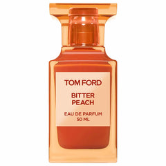 Tom Ford Bitter Peach Eau de Parfum 50ml perfume bottle features an amber-orange glass design, a fluted cap, and a white label with "TOM FORD BITTER PEACH" above peach-colored liquid