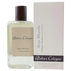 Atelier Cologne Bois Blonds Cologne Absolue 100ml, a clear rectangular bottle with a dark brown cap and light beige label, displayed beside its white box on a minimalist background, featuring 'pure perfume' text